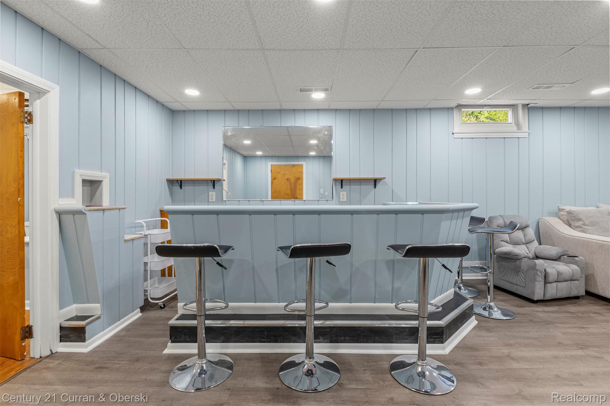 411 South Adrian Street Tecumseh, MI 49286 - Photo 30 of 61 Indoor dry bar with light wood-type flooring, a drop ceiling, and wood walls
