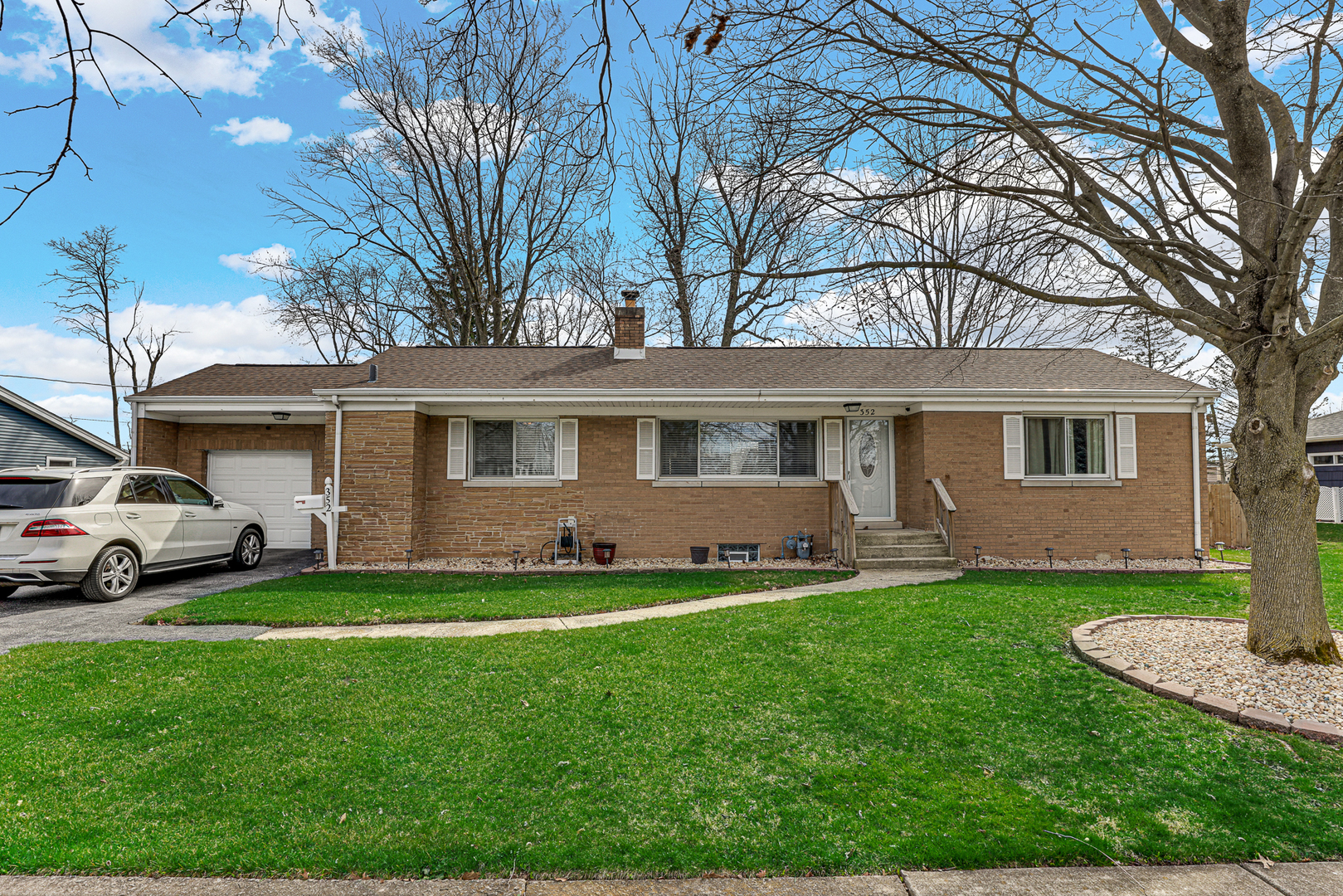 352 Cass Street Crete, IL 60417 - Photo 2 of 21 a front view of a house with a garden and yard