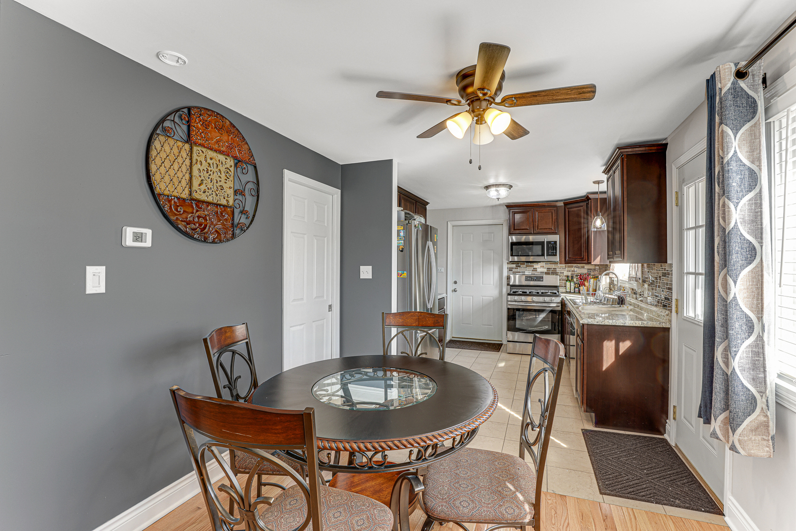 352 Cass Street Crete, IL 60417 - Photo 8 of 21 a dining room with chandelier fan and wooden floor