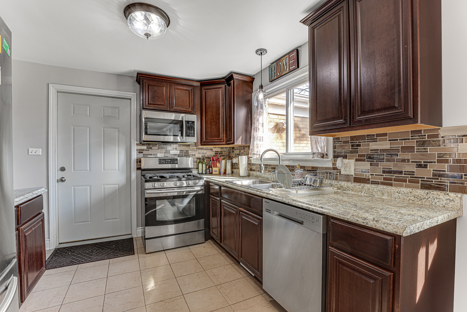 352 Cass Street Crete, IL 60417 - Photo 10 of 21 a kitchen with stainless steel appliances granite countertop a sink stove and refrigerator