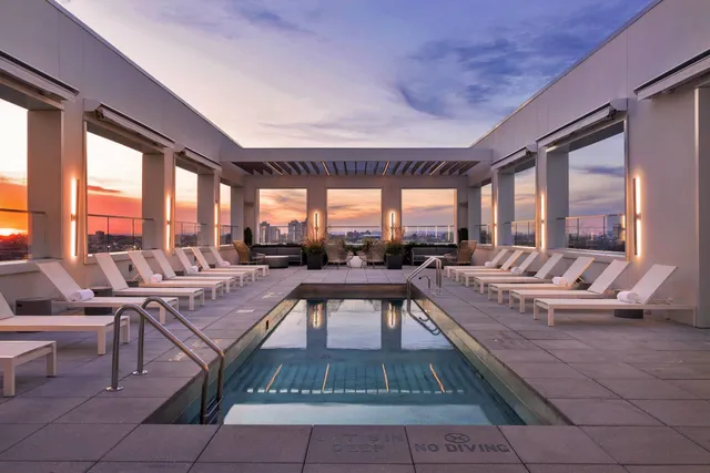 a living room with patio furniture and a large window