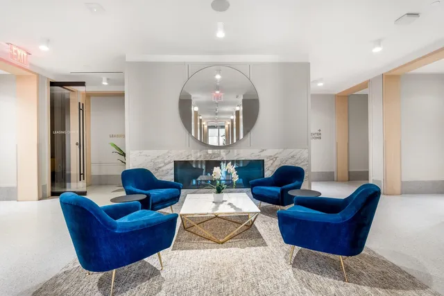 a living room with furniture and a large mirror