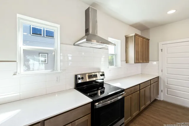 a kitchen with a stove and a white cabinets