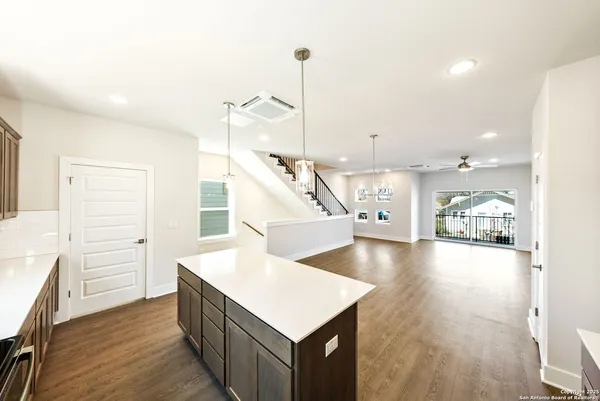 a kitchen view with wooden floor and staircase
