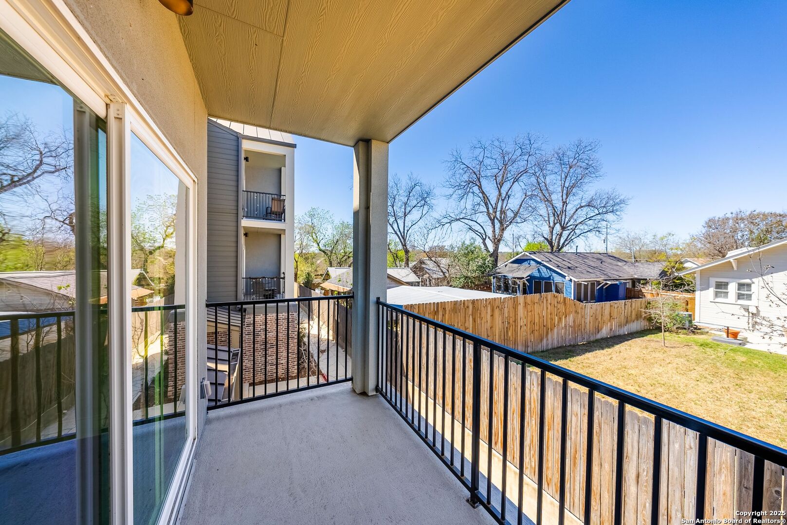 419 Ira Avenue, Unit 2101 San Antonio, TX 78209 - Photo 15 of 23 a view of a porch with wooden floor and iron fence