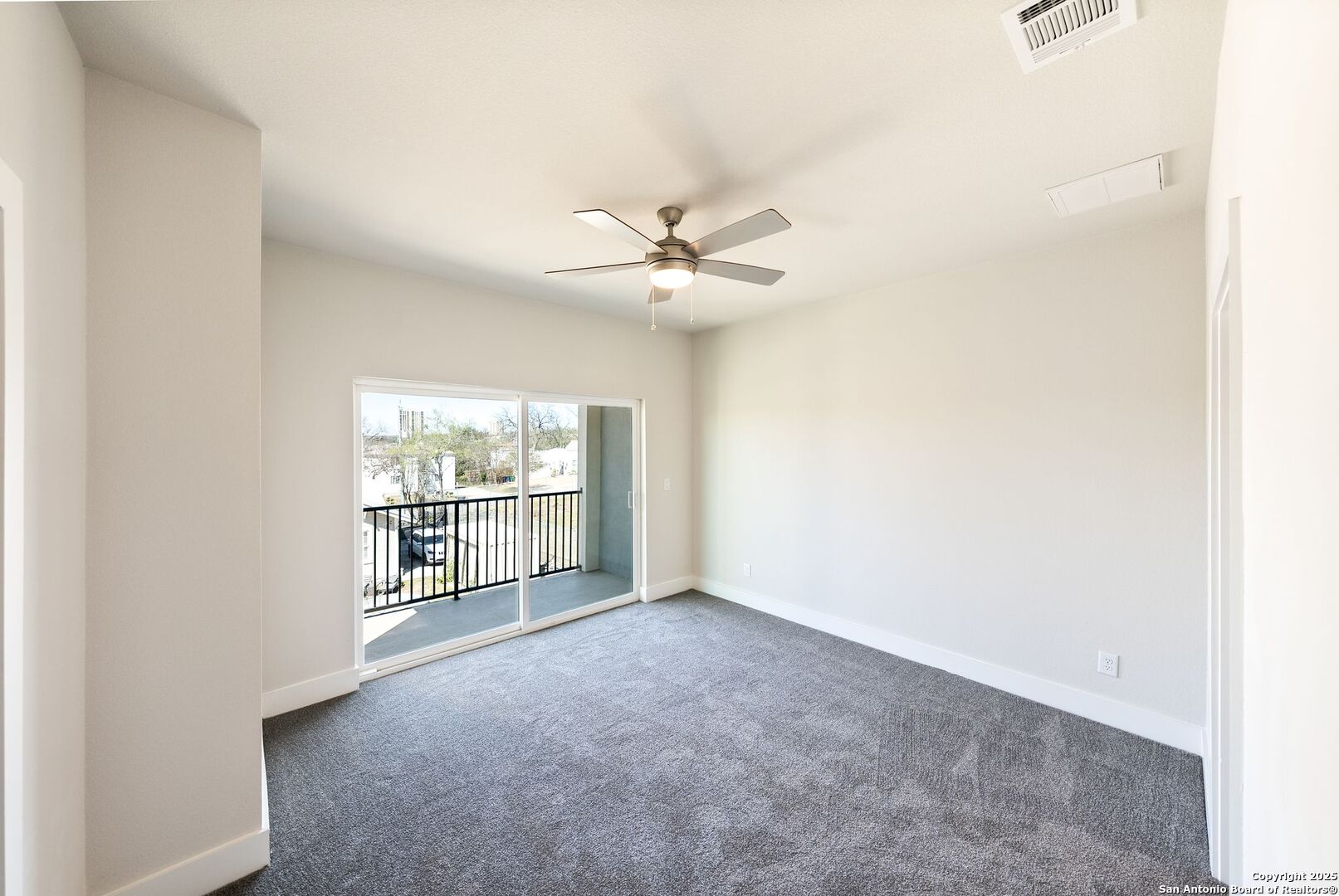 419 Ira Avenue, Unit 2101 San Antonio, TX 78209 - Photo 18 of 23 an empty room with windows and ceiling fan