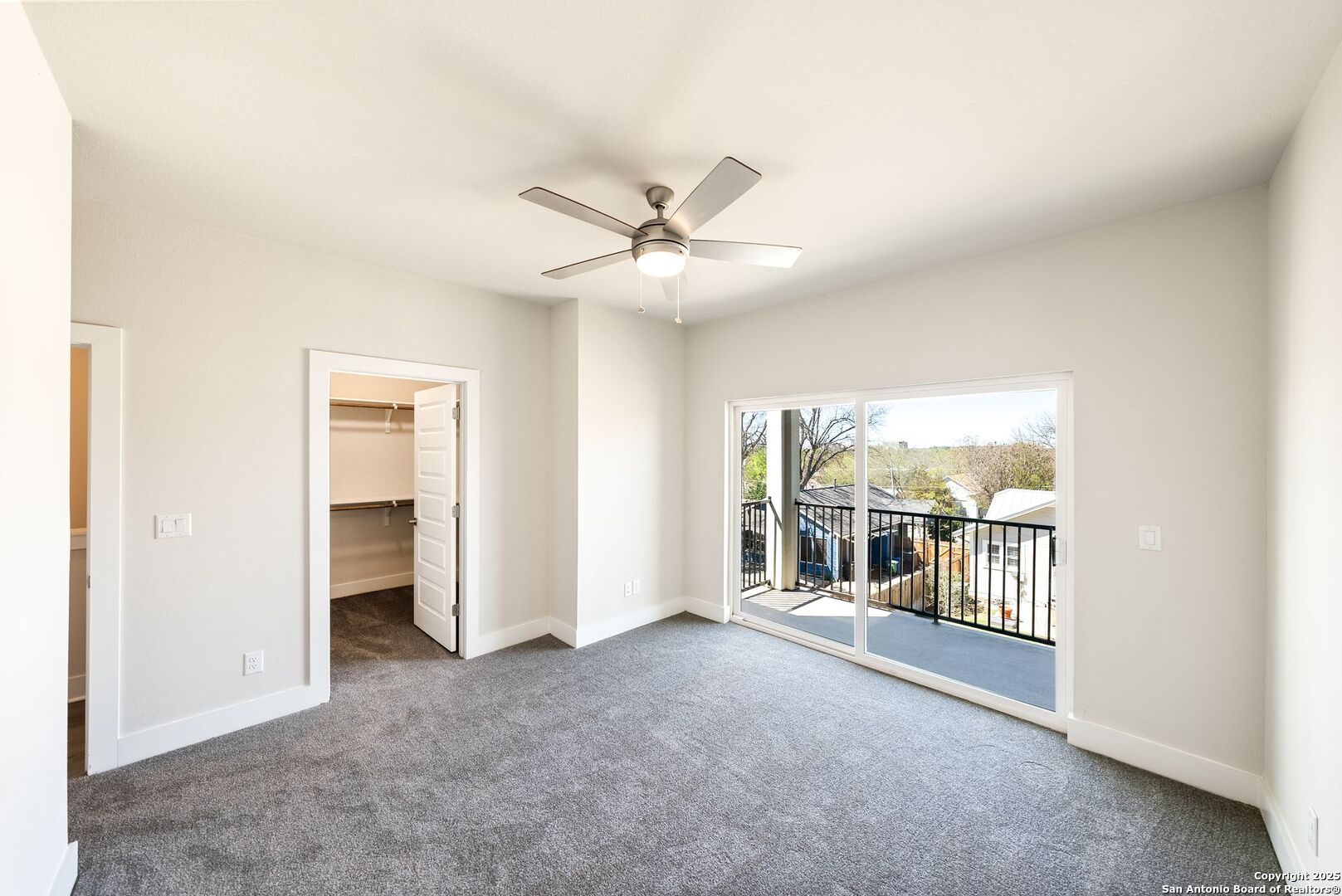 419 Ira Avenue, Unit 2101 San Antonio, TX 78209 - Photo 19 of 23 an empty room with chandelier fan and windows