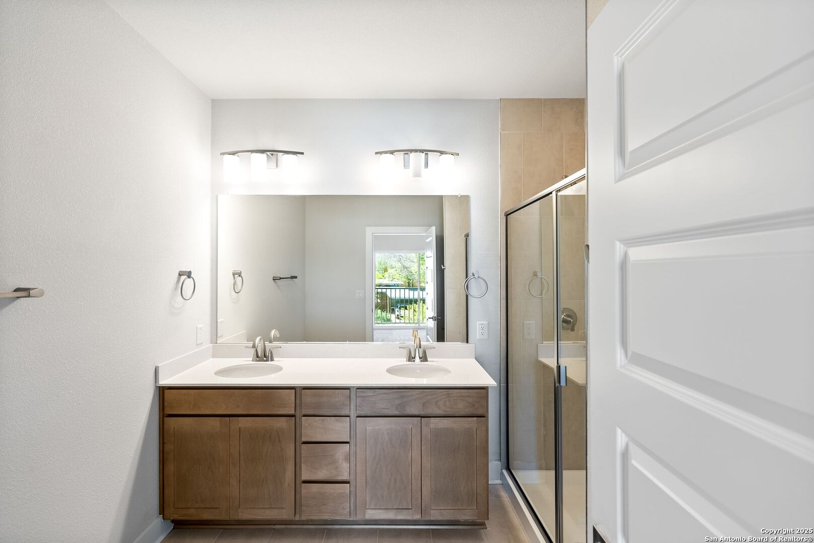 419 Ira Avenue, Unit 2101 San Antonio, TX 78209 - Photo 20 of 23 a bathroom with a sink mirror and a shower