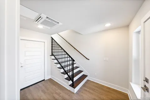 a view of a hallway with stairs