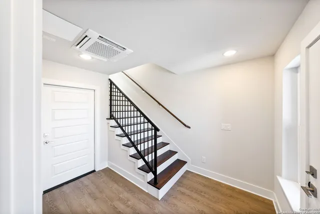 a view of a hallway with stairs