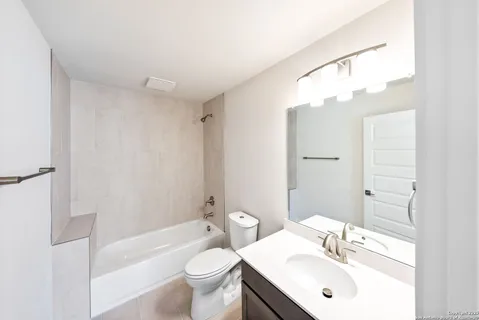 a bathroom with a sink toilet a mirror and shower