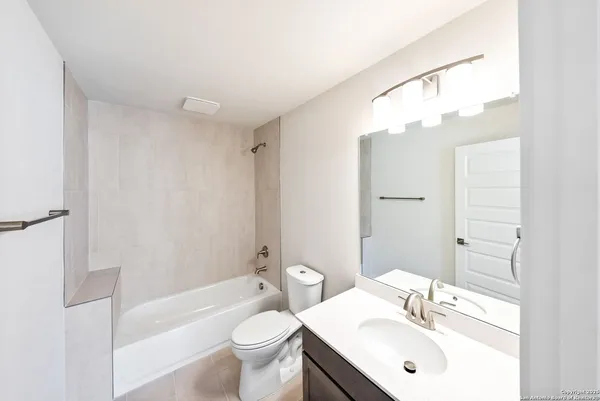 a bathroom with a sink toilet a mirror and shower