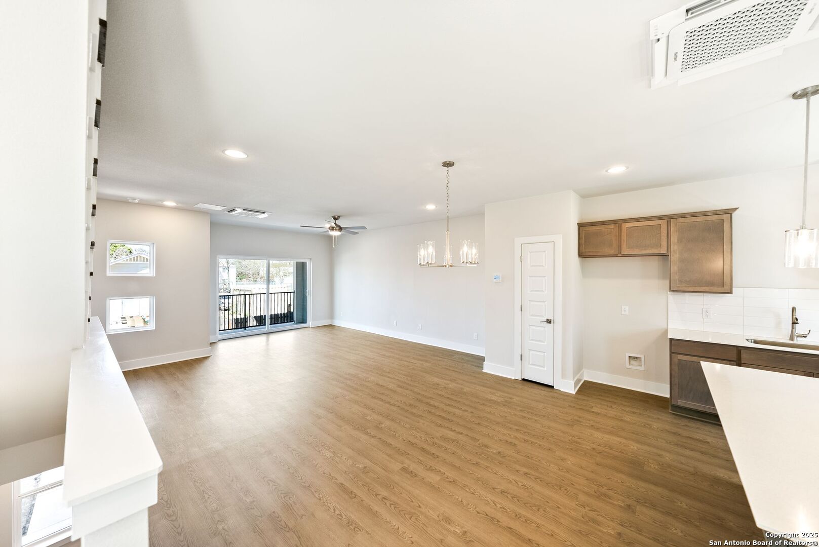419 Ira Avenue, Unit 2101 San Antonio, TX 78209 - Photo 6 of 23 a view of a big room with wooden floor and windows