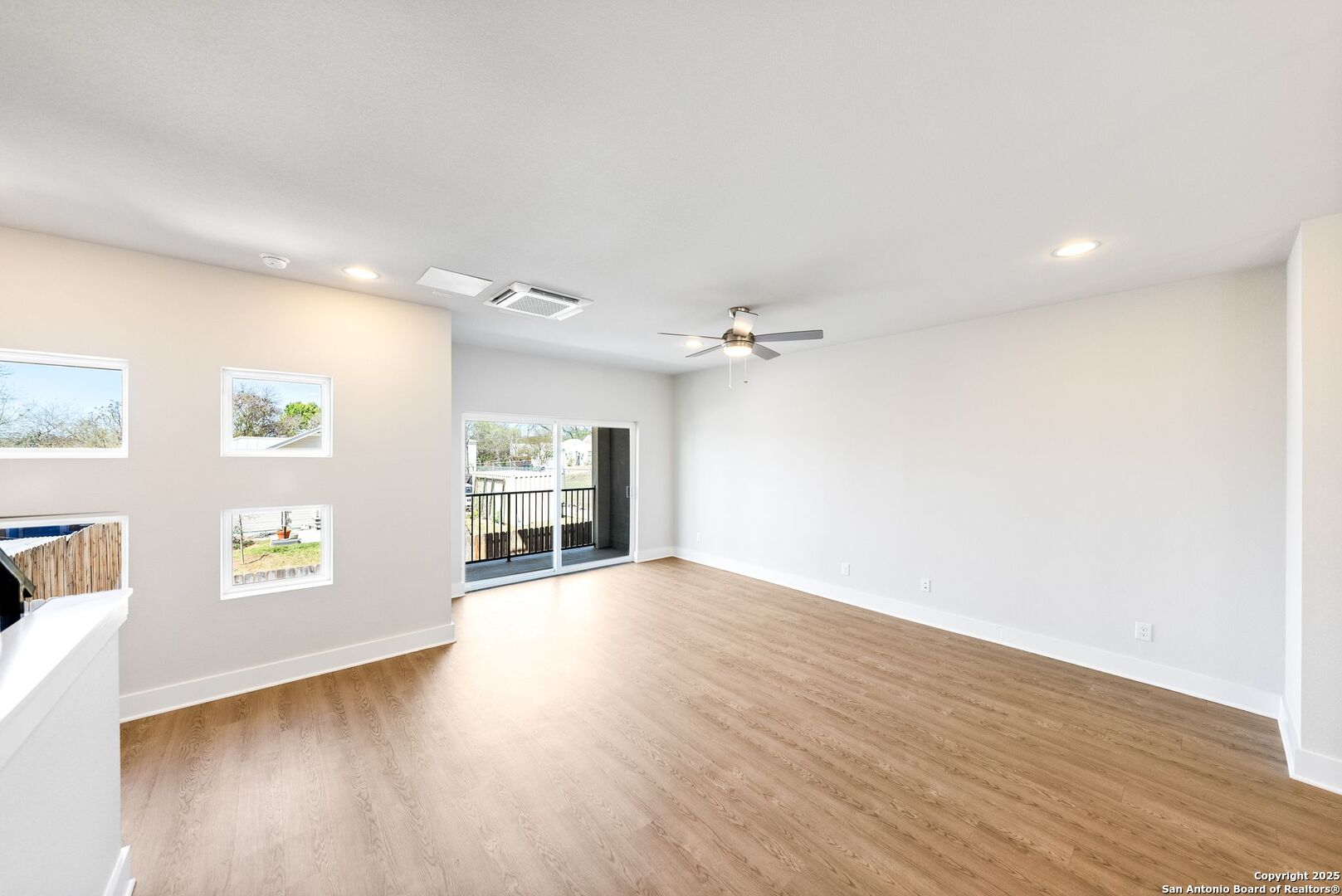 419 Ira Avenue, Unit 2101 San Antonio, TX 78209 - Photo 7 of 23 an empty room with windows and cabinet