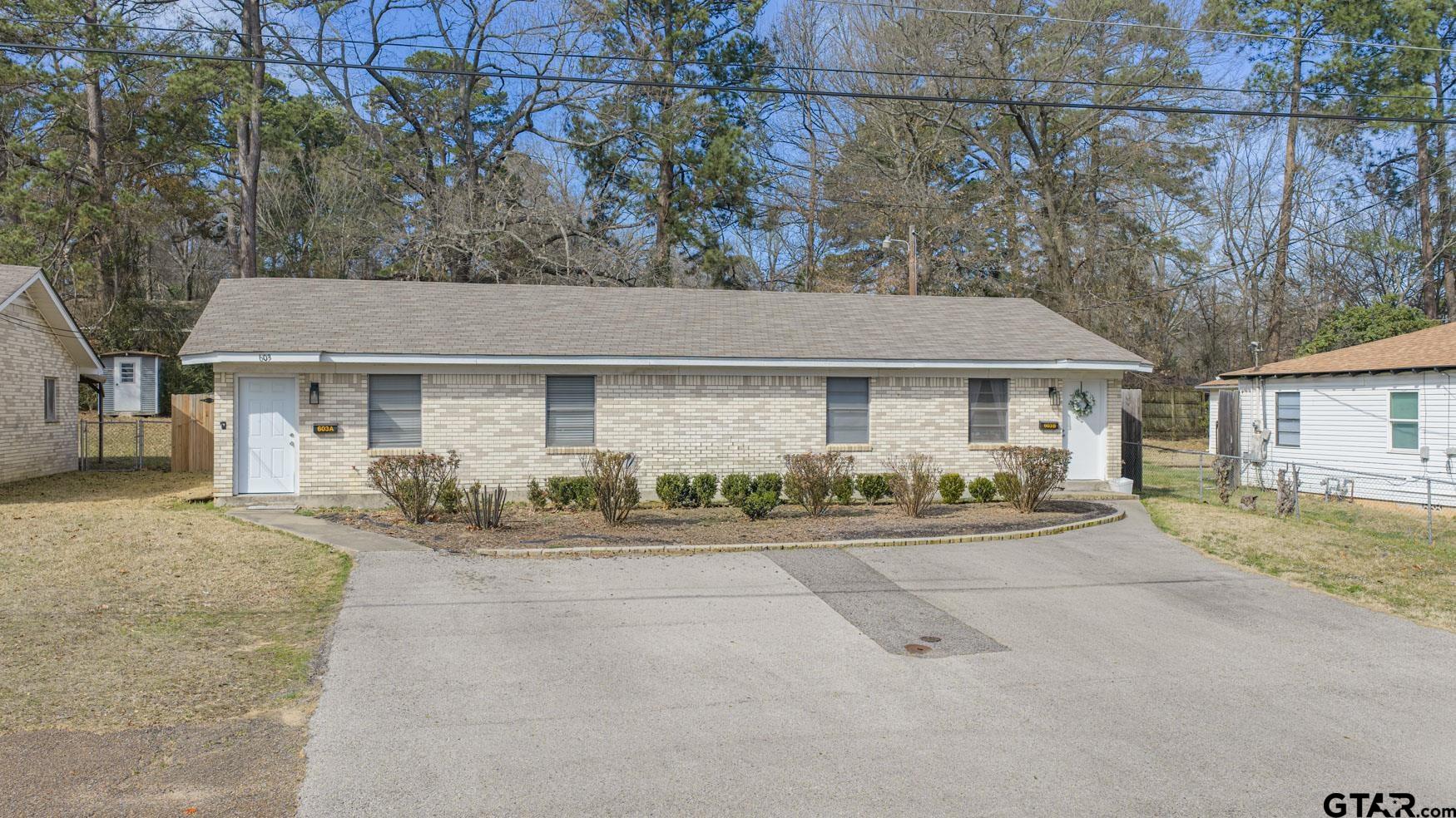 a front view of a house with a yard and a garage