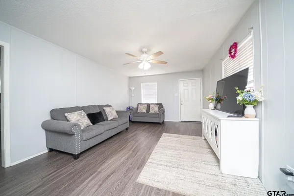 a living room with furniture and a chandelier