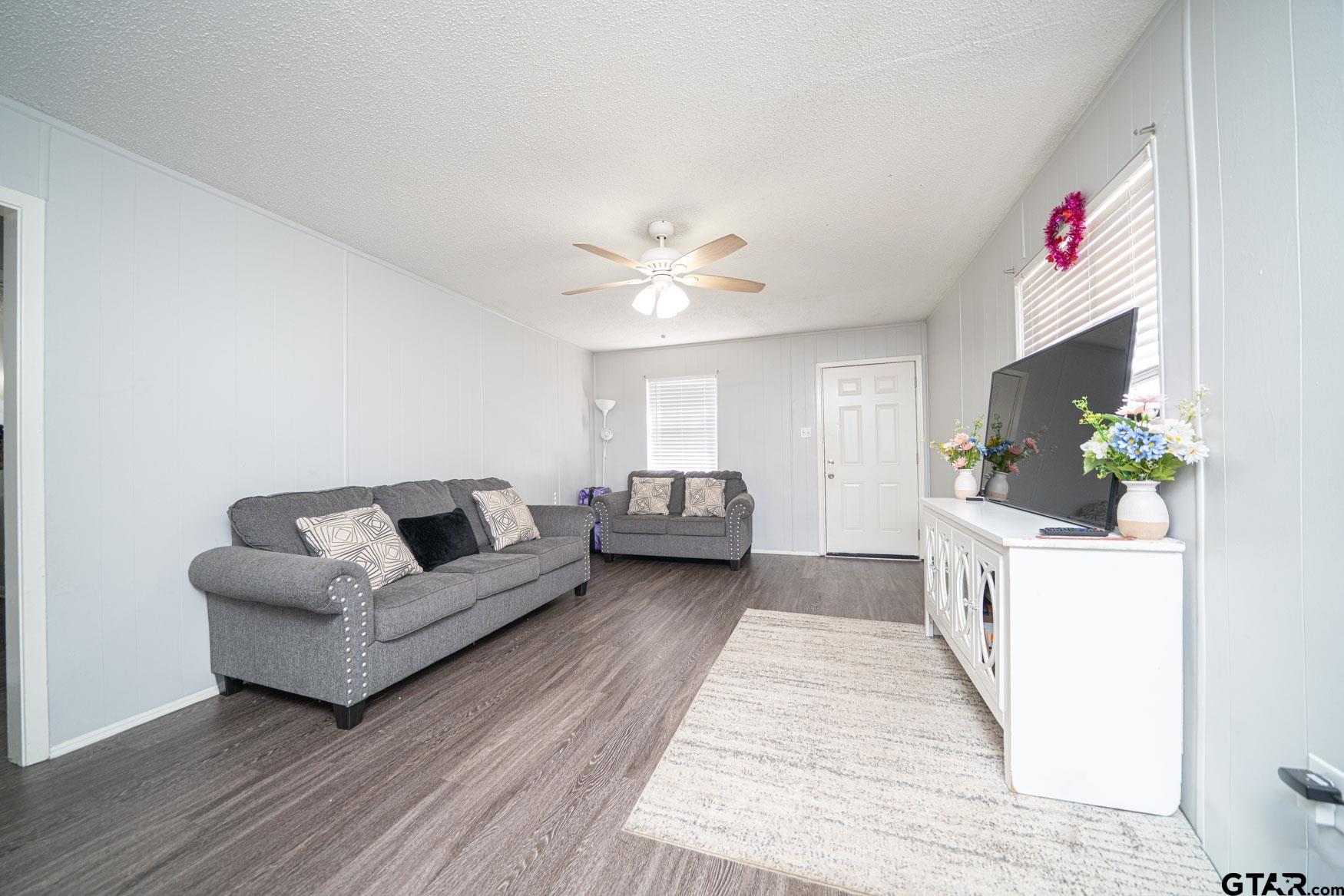 603 Waggoner Street Longview, TX 75604 - Photo 11 of 22 a living room with furniture and a chandelier