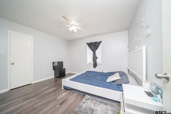 a living room with wooden floor and furniture