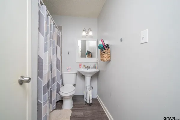 a bathroom with a toilet sink and a mirror