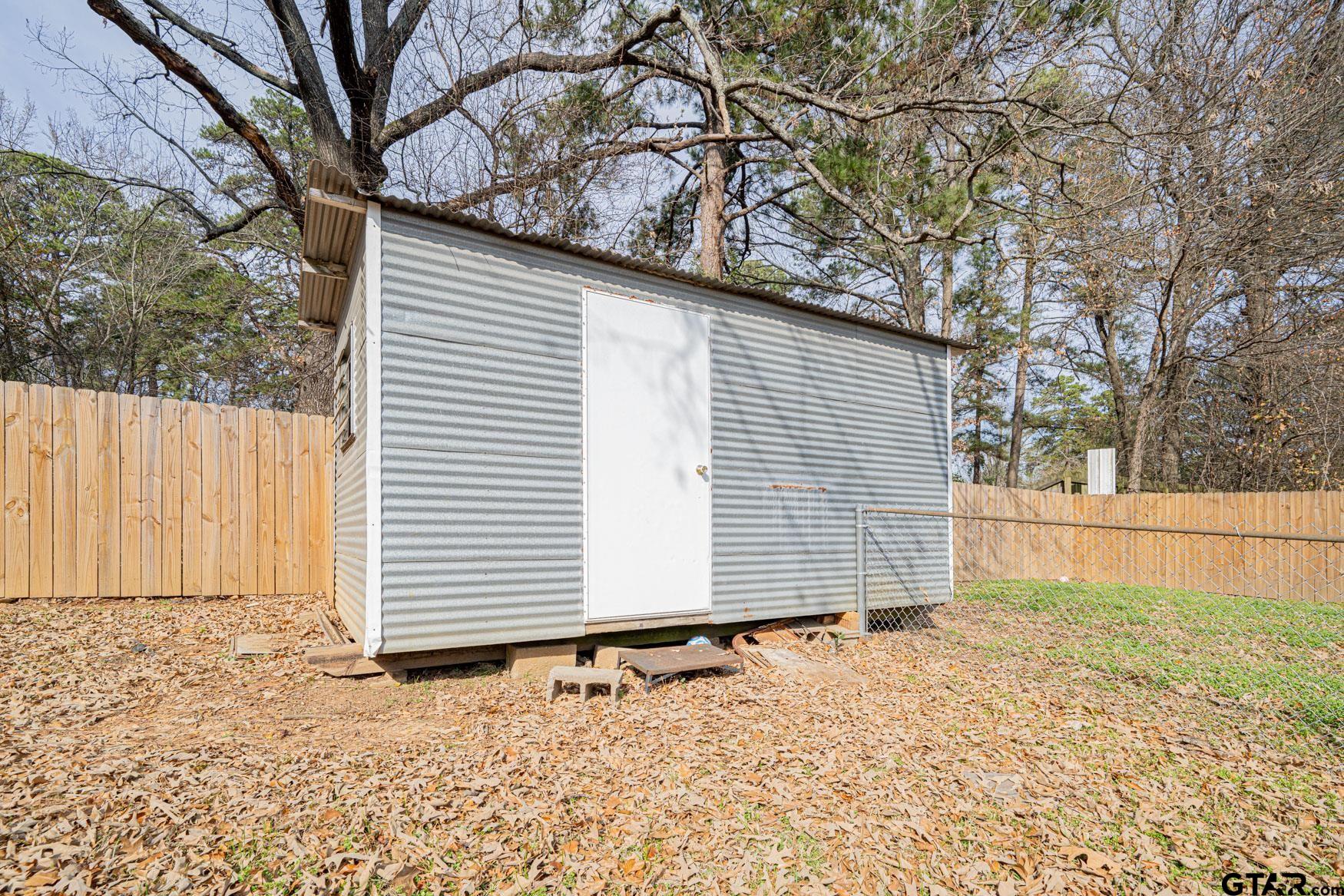 603 Waggoner Street Longview, TX 75604 - Photo 19 of 22 a view of a backyard with a large tree