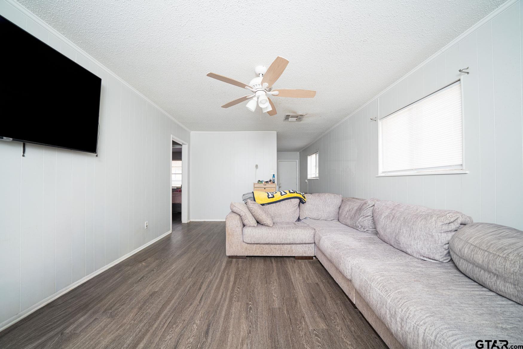 603 Waggoner Street Longview, TX 75604 - Photo 2 of 22 a living room with furniture and a flat screen tv