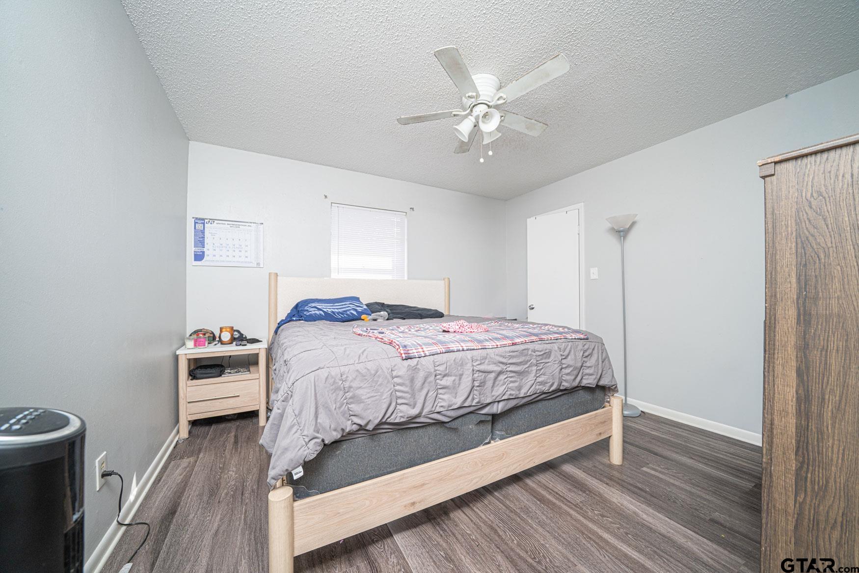 603 Waggoner Street Longview, TX 75604 - Photo 6 of 22 a bedroom with a bed and a chandelier