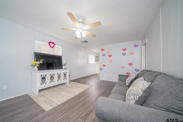 a living room with furniture and a flat screen tv