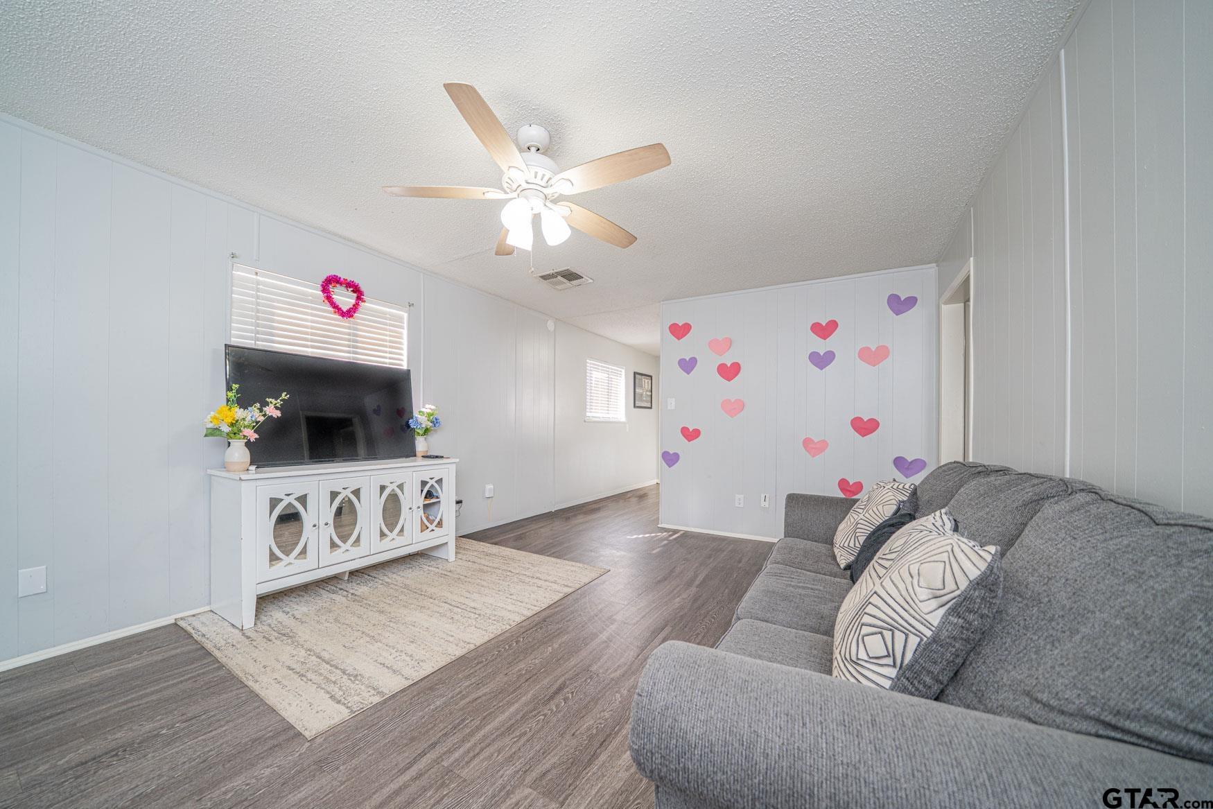 603 Waggoner Street Longview, TX 75604 - Photo 10 of 22 a living room with furniture and a flat screen tv