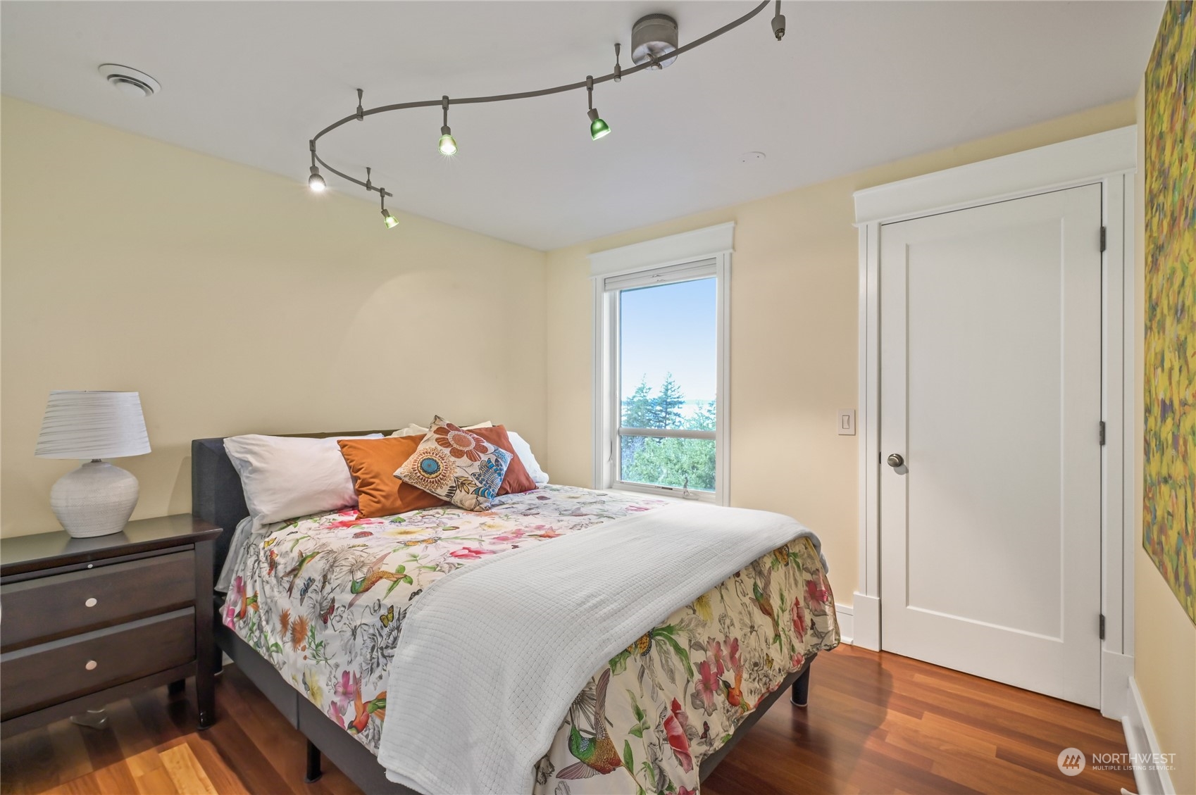 711 Briar Road Bellingham, WA 98225 - Photo 35 of 40 a bedroom with a bed and wooden floor