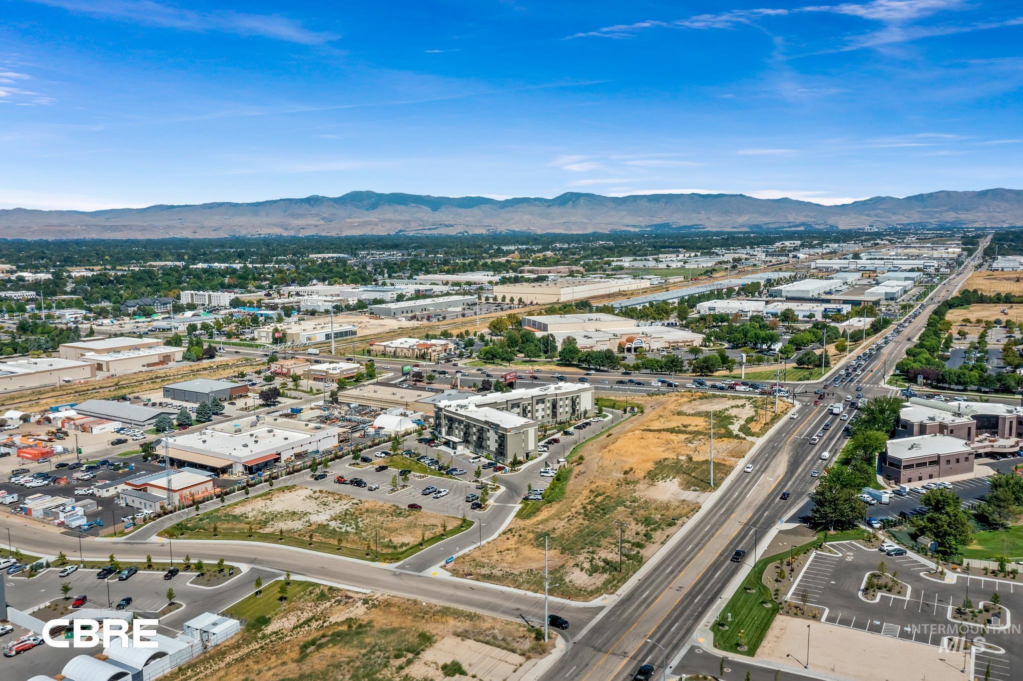 3070 East Franklin Road Meridian, ID 83642 - Photo 9 of 18 Aerial view of property and surrounding area featuring a mountain backdrop