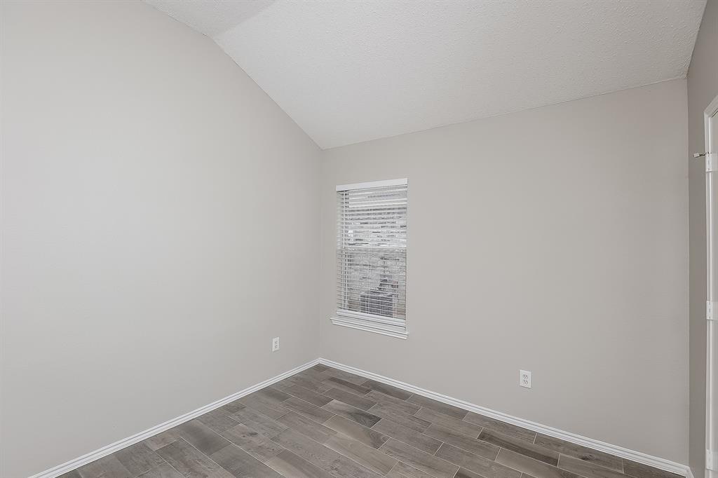 7417 Snow Ridge Drive Fort Worth, TX 76133 - Photo 12 of 16 a view of an empty room with wooden floor and a window