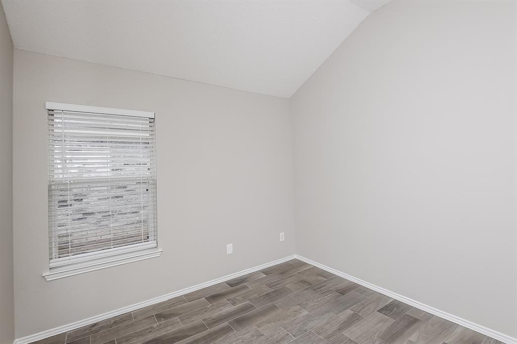 7417 Snow Ridge Drive Fort Worth, TX 76133 - Photo 13 of 16 wooden floor in an empty room with a window