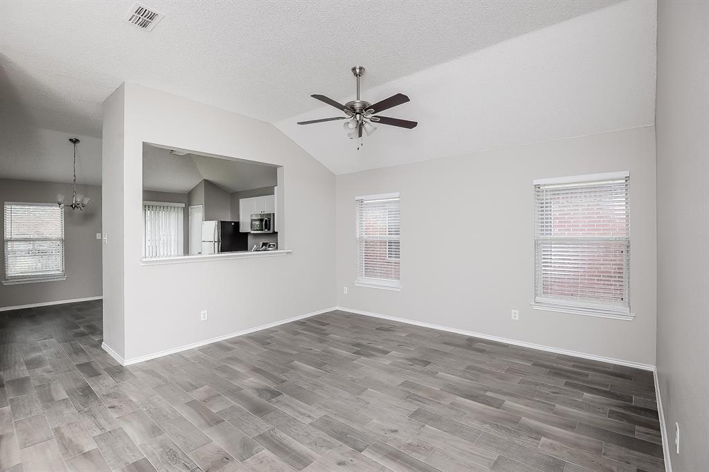 7417 Snow Ridge Drive Fort Worth, TX 76133 - Photo 5 of 16 wooden floor in an empty room with a window