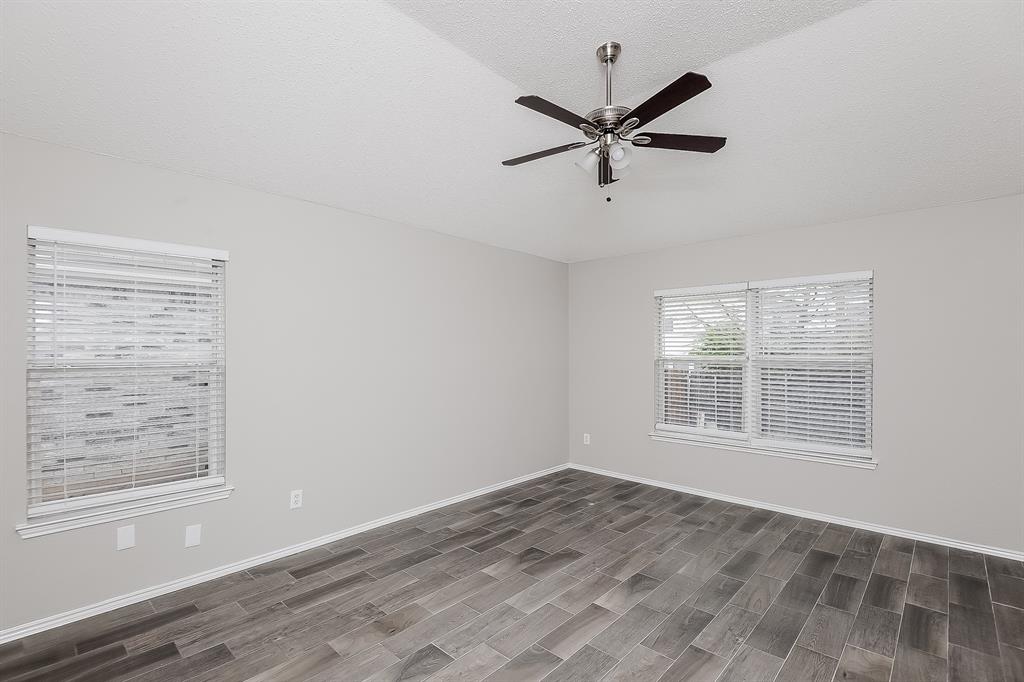 7417 Snow Ridge Drive Fort Worth, TX 76133 - Photo 9 of 16 a view of a livingroom with a ceiling fan and window