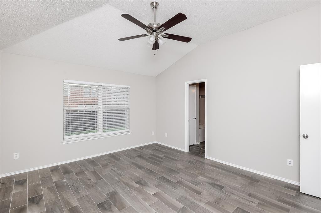 7417 Snow Ridge Drive Fort Worth, TX 76133 - Photo 10 of 16 an empty room with wooden floor and windows