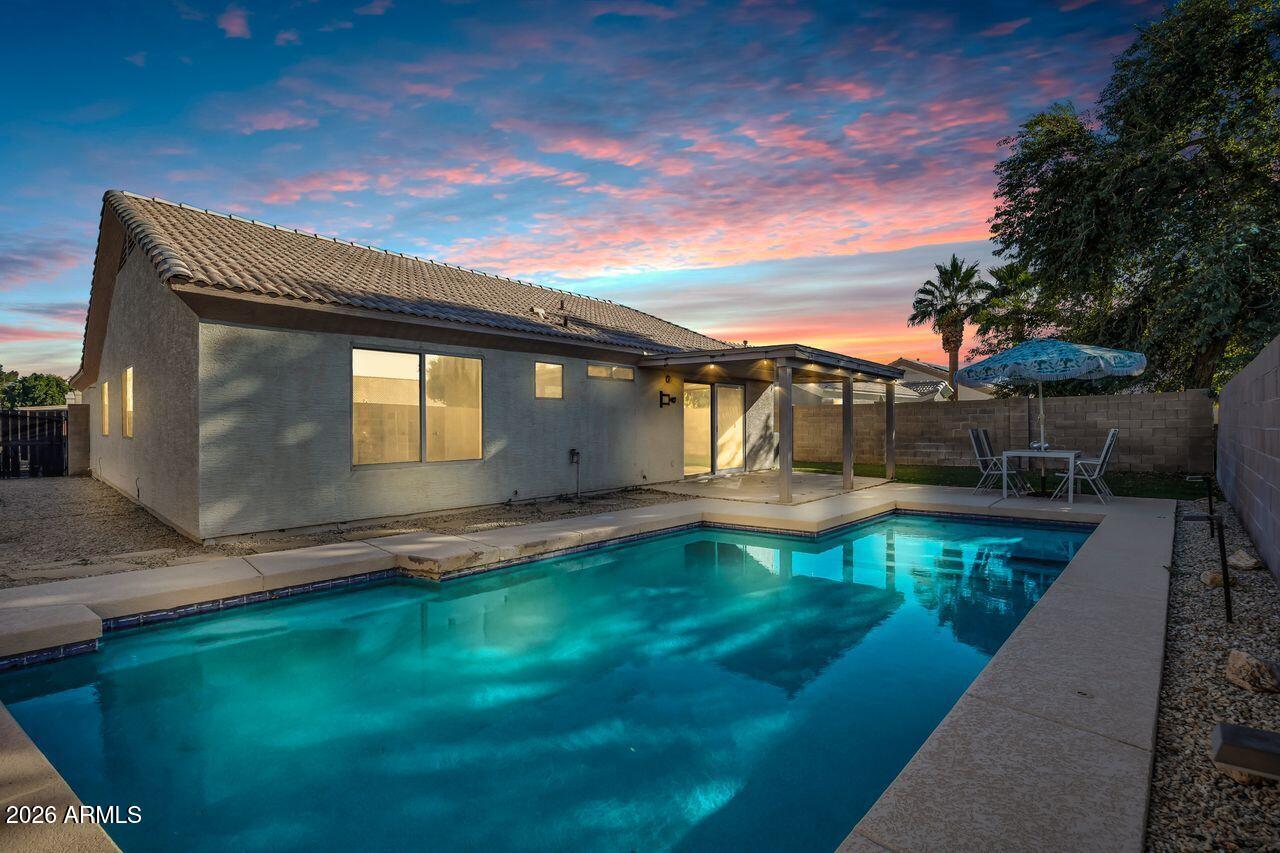 a view of a swimming pool with a yard