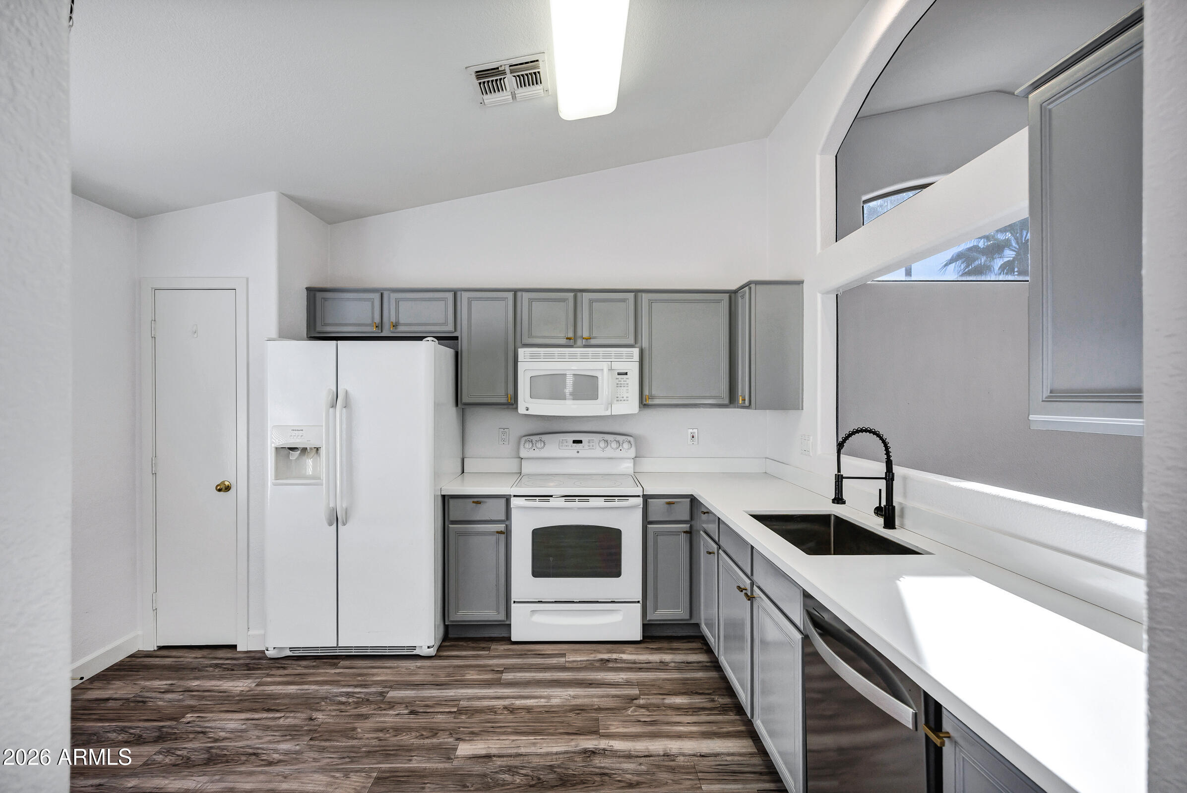 56 South Monterey Street Gilbert, AZ 85233 - Photo 13 of 30 a kitchen with a sink a stove and refrigerator