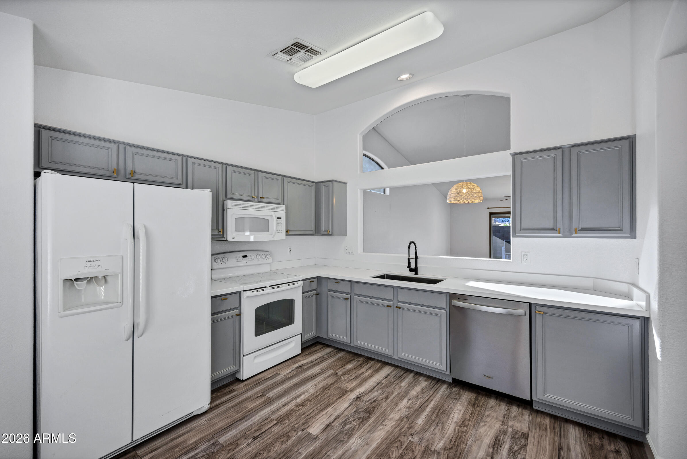56 South Monterey Street Gilbert, AZ 85233 - Photo 14 of 30 a kitchen with white cabinets and white appliances