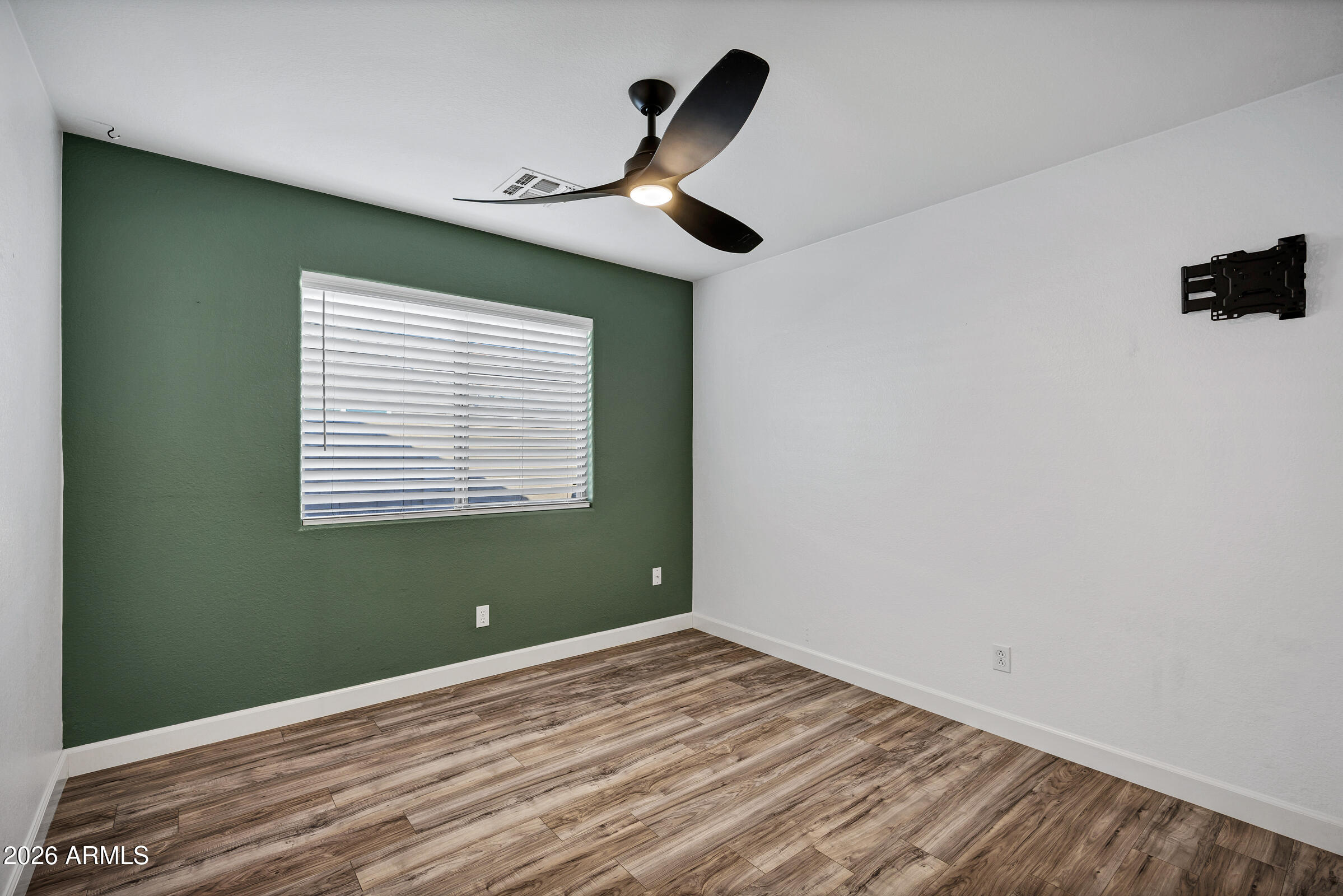 56 South Monterey Street Gilbert, AZ 85233 - Photo 17 of 30 a view of a room with a large window ceiling fan and wooden floor