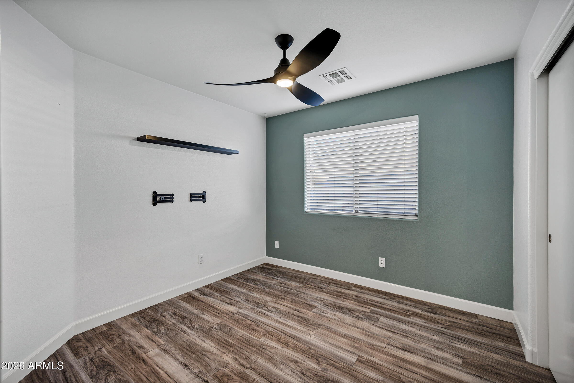 56 South Monterey Street Gilbert, AZ 85233 - Photo 18 of 30 a view of empty room with wooden floor and fan