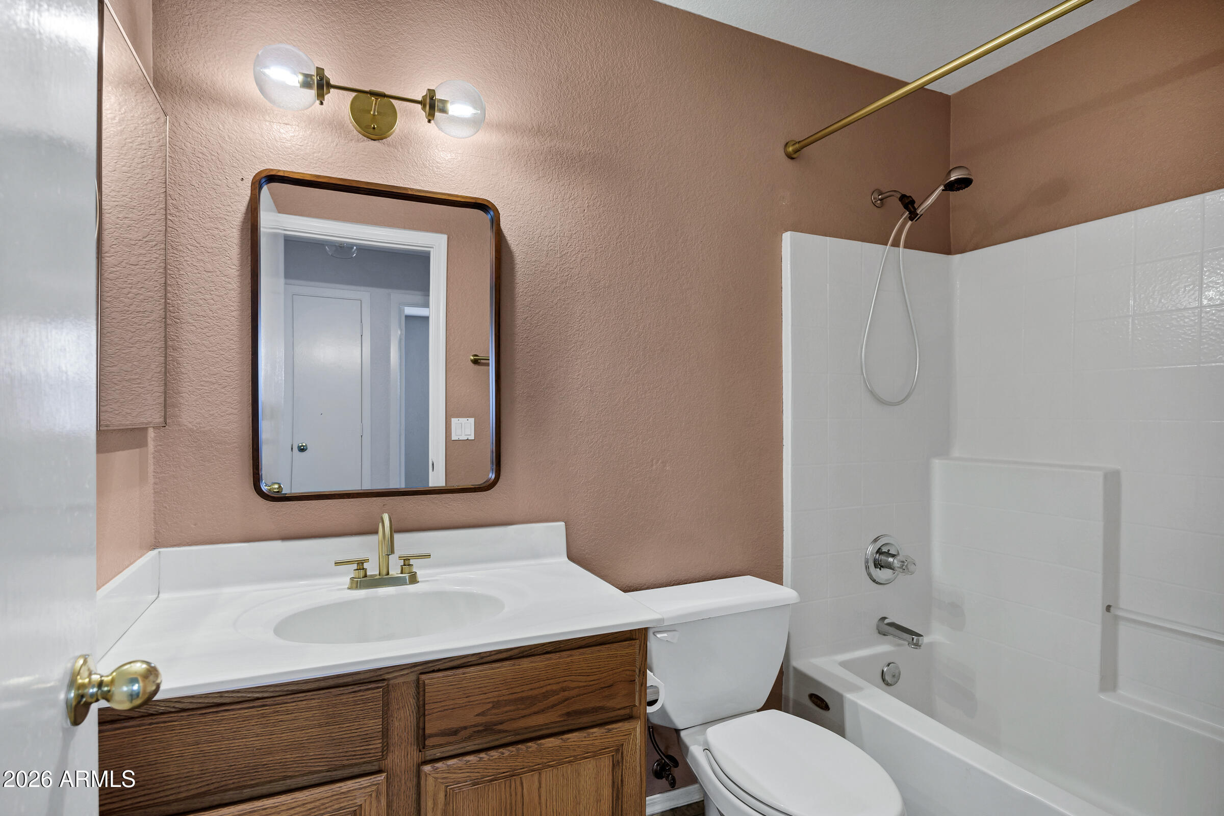 56 South Monterey Street Gilbert, AZ 85233 - Photo 19 of 30 a bathroom with a granite countertop sink toilet a mirror and shower