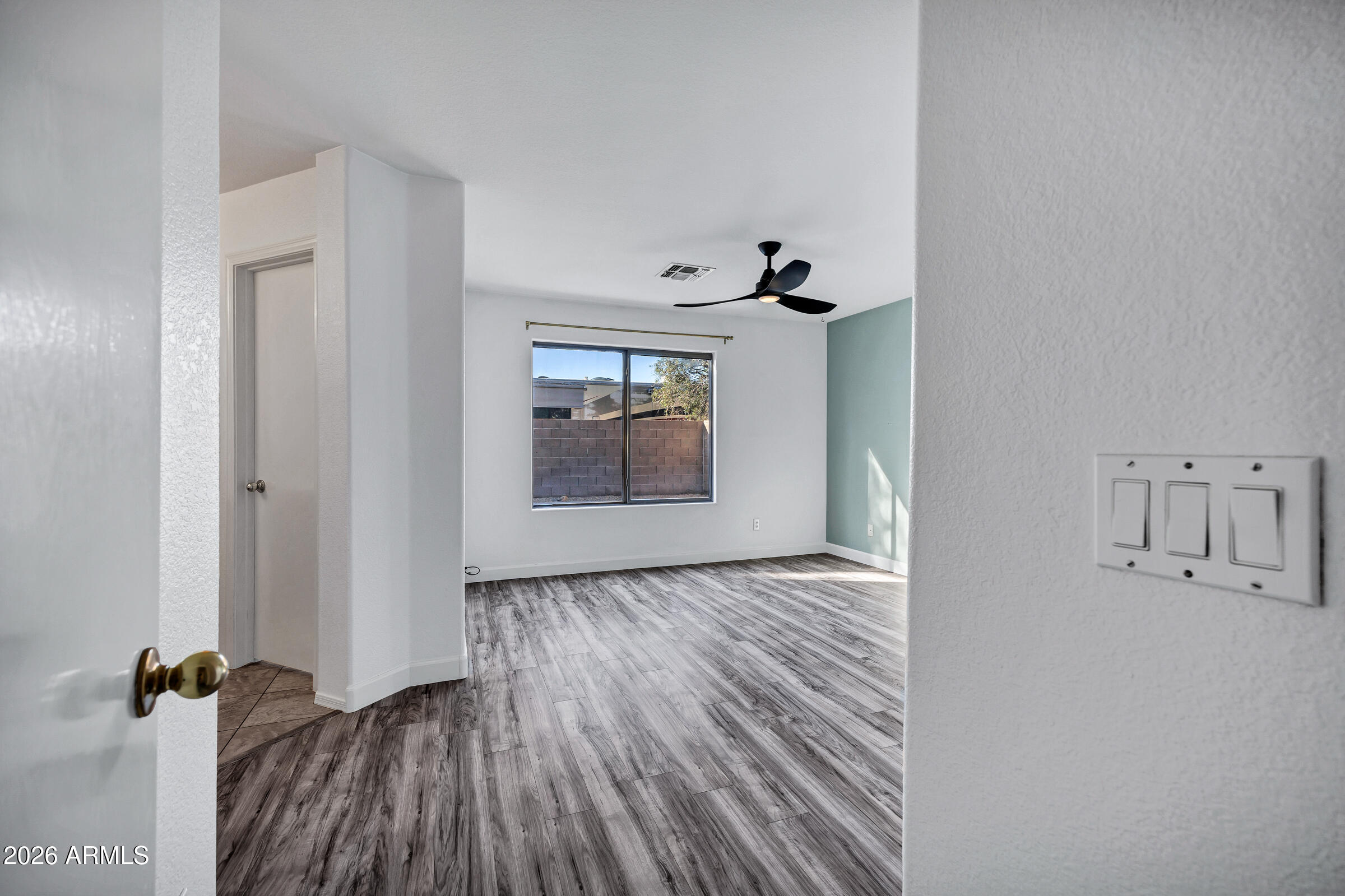 56 South Monterey Street Gilbert, AZ 85233 - Photo 20 of 30 an empty room with wooden floor and windows