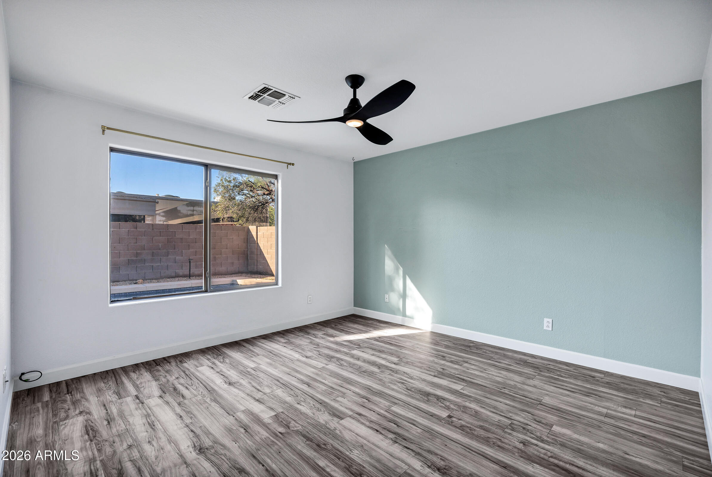 56 South Monterey Street Gilbert, AZ 85233 - Photo 21 of 30 a view of an empty room with wooden floor and a window