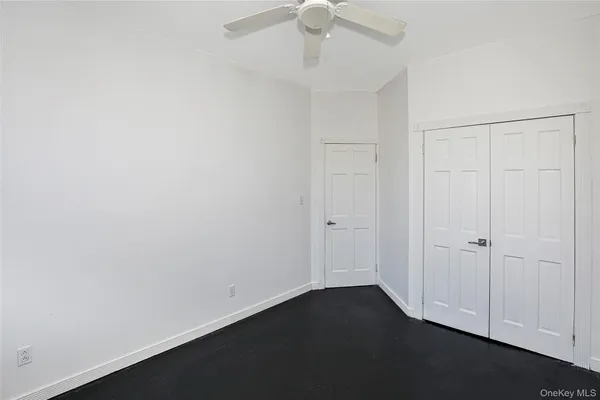 an empty room with a ceiling fan