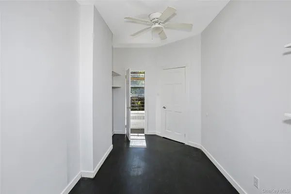 a view of empty room with closet and fan