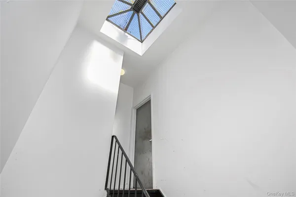 a view of staircase with white walls and a window