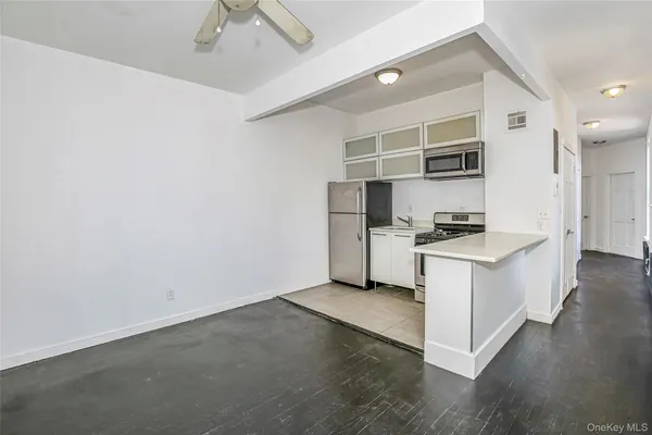 a kitchen with cabinets and wooden floor