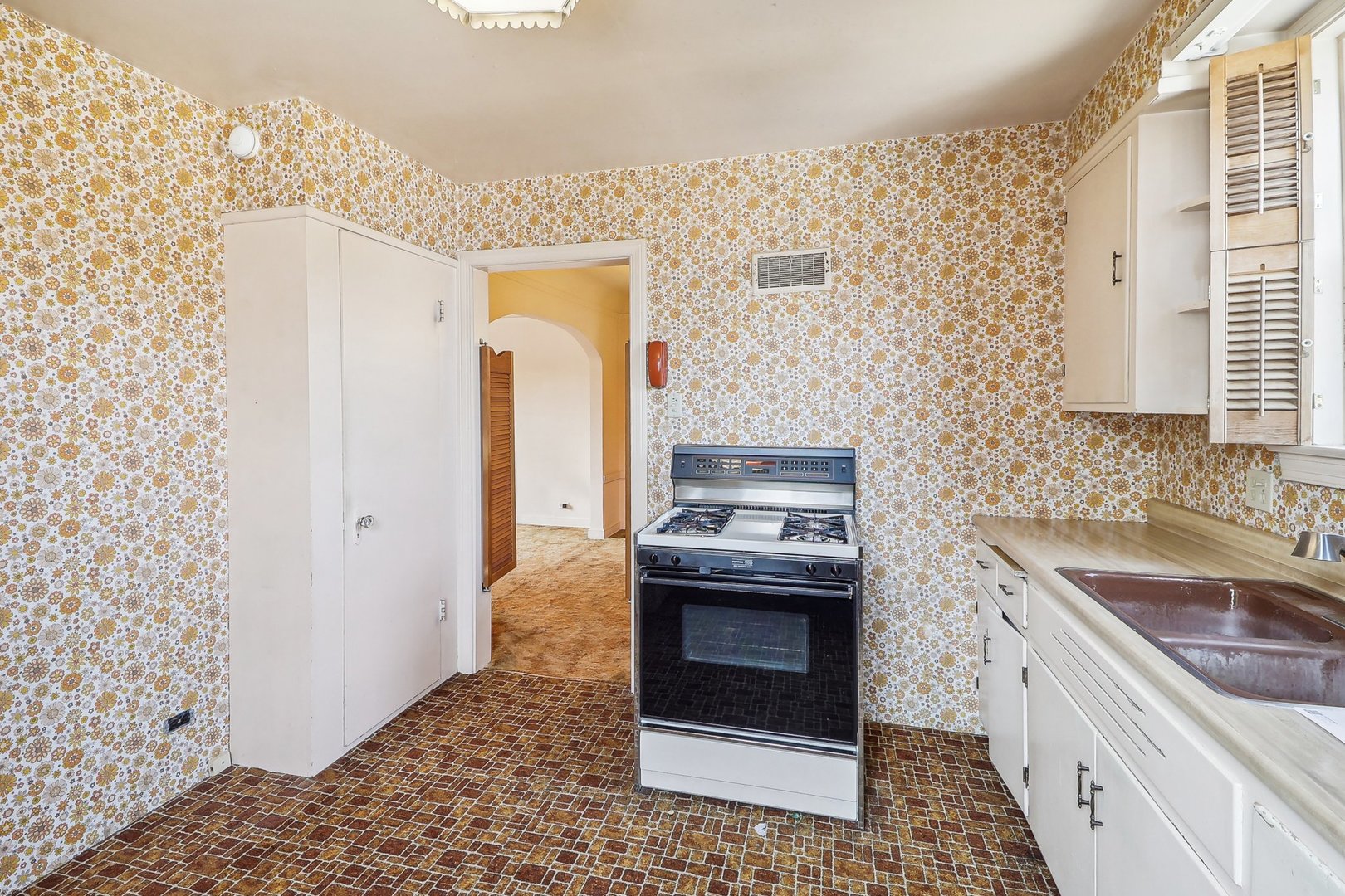 6014 West Fletcher Street Chicago, IL 60634 - Photo 12 of 28 a kitchen with stainless steel appliances granite countertop a sink stove and refrigerator