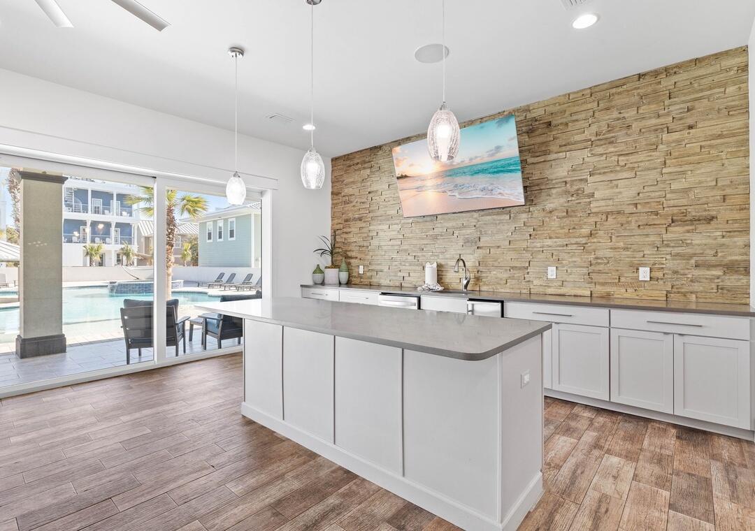 151 Snowdrift Road Miramar Beach, FL 32550 - Photo 13 of 50 a kitchen with stainless steel appliances granite countertop a sink cabinets and wooden floor