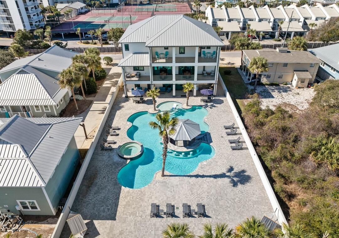 151 Snowdrift Road Miramar Beach, FL 32550 - Photo 40 of 50 an aerial view of a house roof deck with couches table and chairs under an umbrella